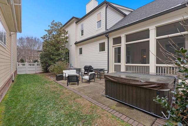 back of property with a lawn, an outdoor living space, a hot tub, and a patio