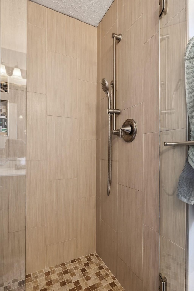 bathroom with tiled shower