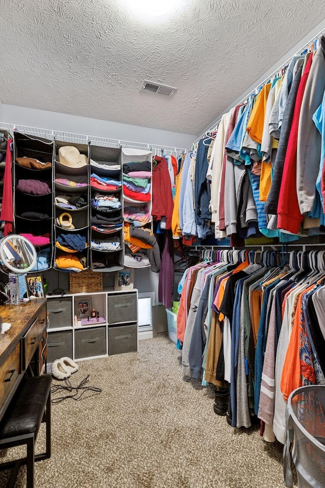 walk in closet with carpet flooring