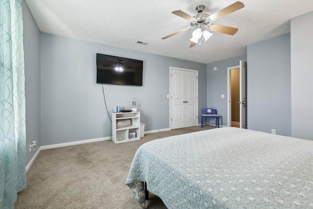 carpeted bedroom featuring a closet and ceiling fan