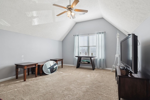 interior space with ceiling fan, a textured ceiling, and carpet floors