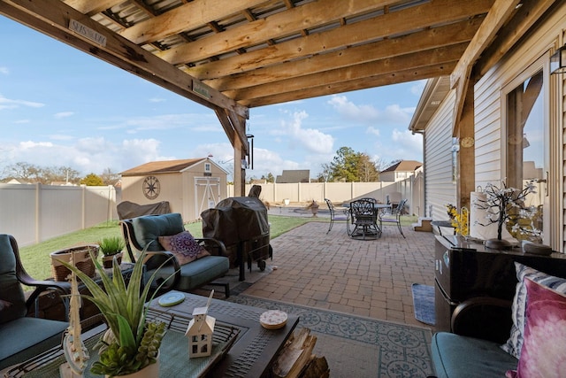 view of patio with a storage unit and grilling area