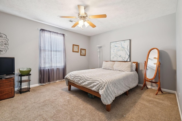 bedroom featuring ceiling fan, a textured ceiling, and carpet floors