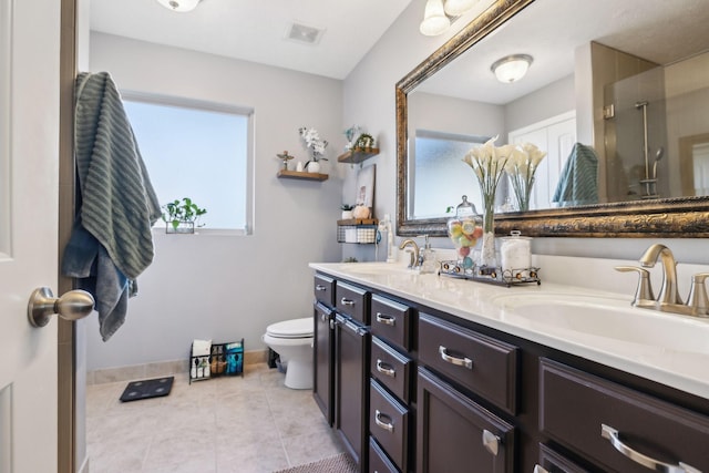 bathroom featuring vanity, toilet, and tile patterned flooring