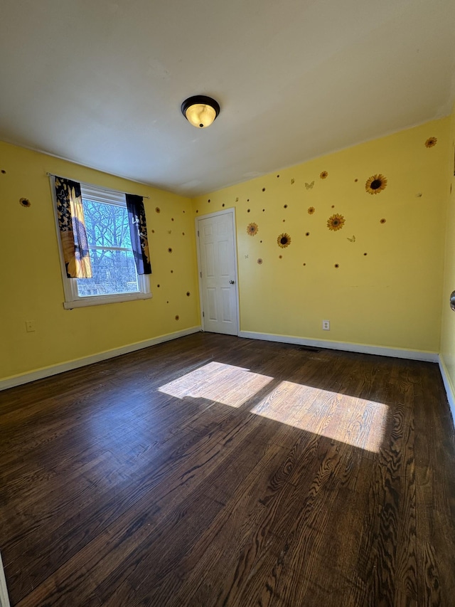 empty room featuring dark hardwood / wood-style flooring