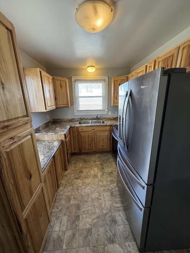 kitchen featuring stainless steel fridge and sink