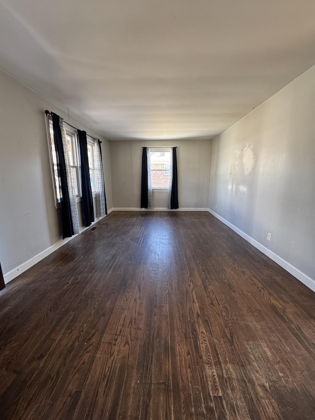 spare room featuring dark wood-type flooring