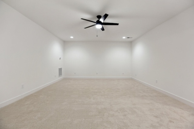 empty room with ceiling fan and light colored carpet