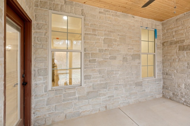 interior space featuring ceiling fan and wood ceiling