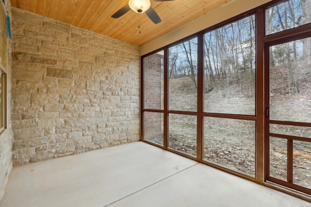 unfurnished sunroom featuring wooden ceiling and ceiling fan