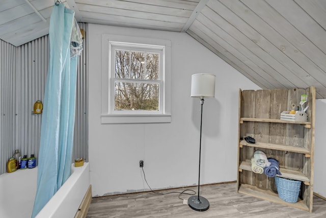 bonus room with light hardwood / wood-style floors and lofted ceiling