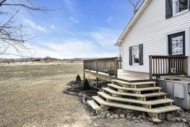 view of yard featuring a wooden deck, central AC, and a rural view