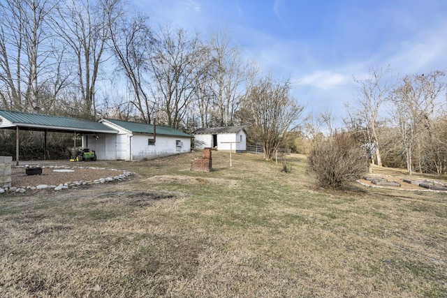 view of yard with a carport and a shed