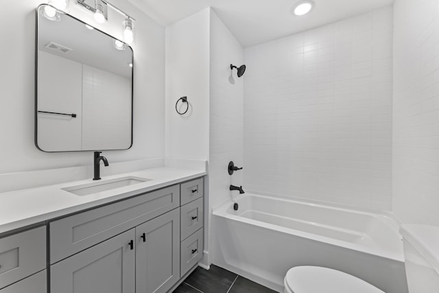 full bathroom featuring toilet, vanity, bathtub / shower combination, and tile patterned floors