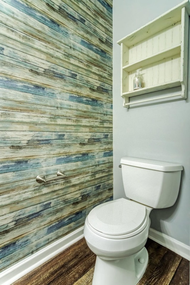 bathroom with hardwood / wood-style floors and toilet