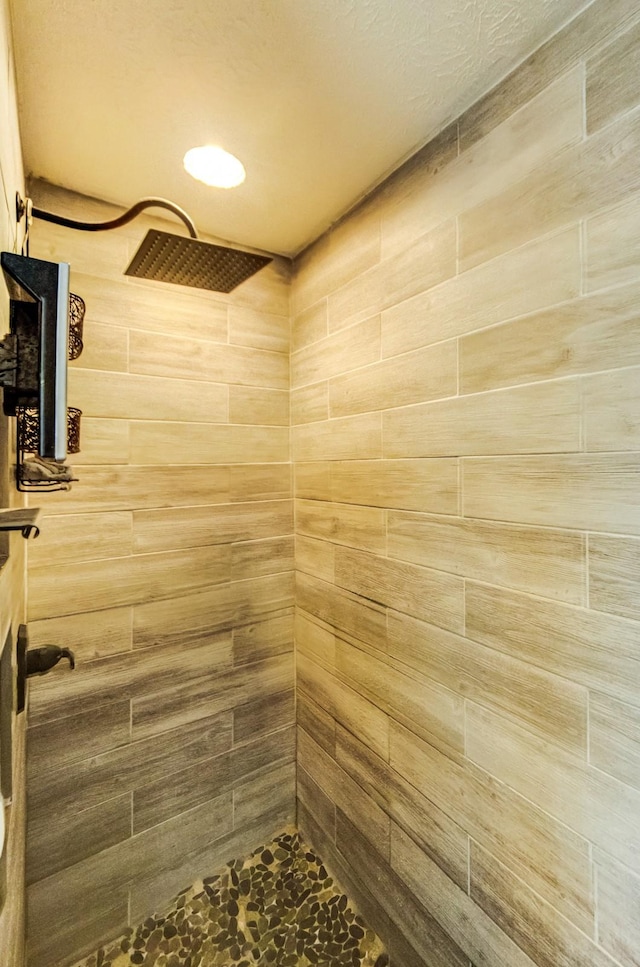 bathroom with tiled shower