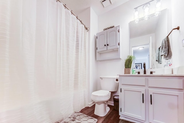 bathroom with vanity, hardwood / wood-style floors, and toilet