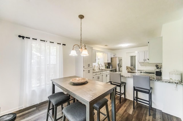 dining room with sink and dark hardwood / wood-style flooring