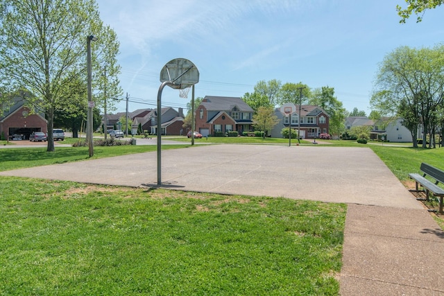 view of sport court featuring a yard