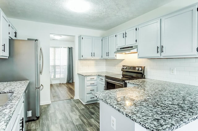 kitchen featuring white cabinetry, light hardwood / wood-style flooring, light stone countertops, and appliances with stainless steel finishes