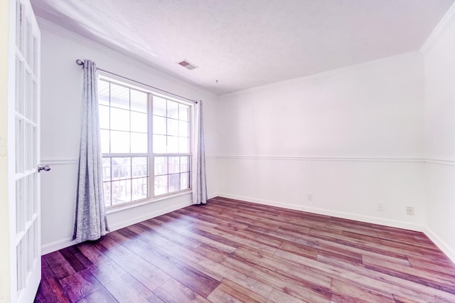 spare room with plenty of natural light and light hardwood / wood-style floors