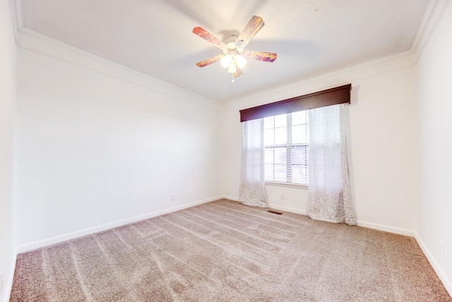 unfurnished room with crown molding, carpet flooring, and ceiling fan