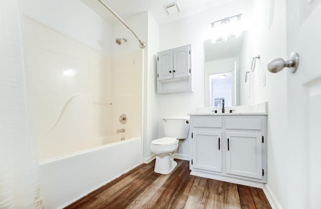 full bathroom with shower / bathing tub combination, vanity, wood-type flooring, and toilet