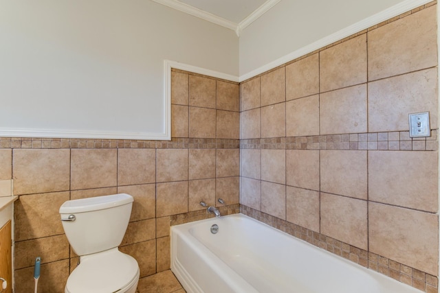 bathroom with a washtub, tile walls, toilet, and crown molding