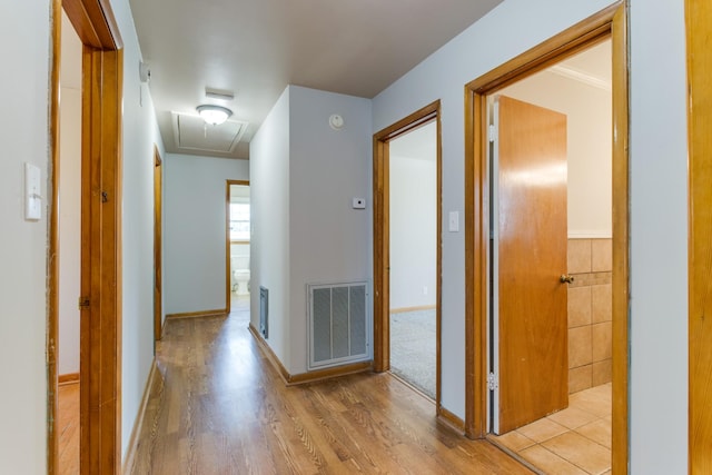 corridor with light hardwood / wood-style flooring