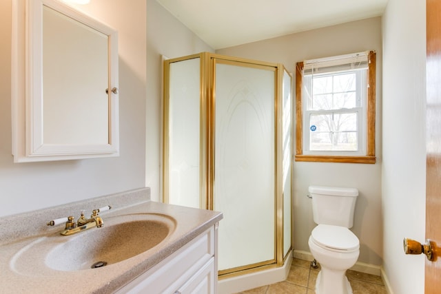 bathroom with a shower with door, tile patterned floors, vanity, and toilet