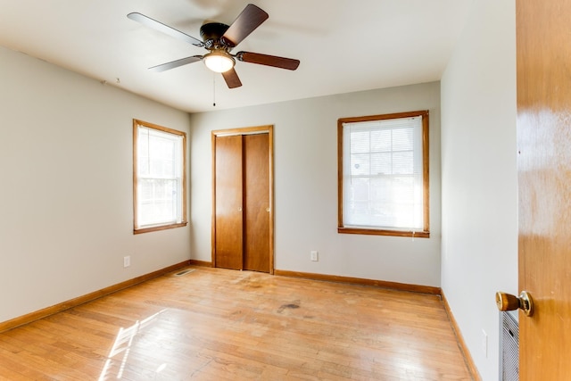 unfurnished bedroom with ceiling fan and light wood-type flooring