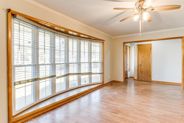 unfurnished room featuring ceiling fan, light wood-type flooring, and crown molding