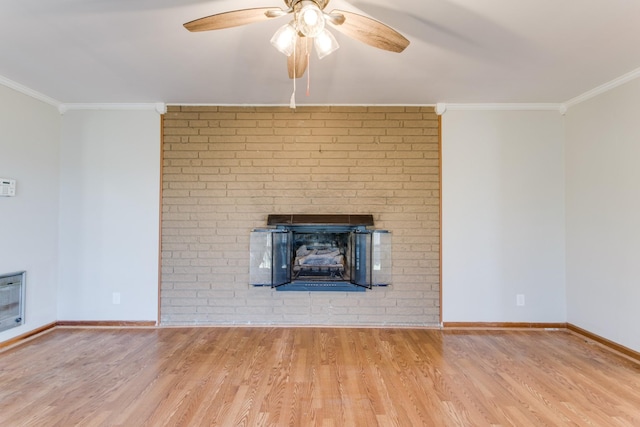 unfurnished living room with ceiling fan, a fireplace, crown molding, light hardwood / wood-style flooring, and heating unit