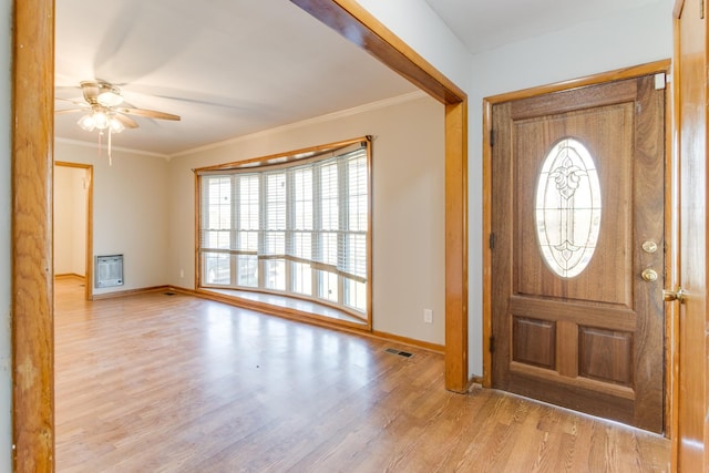 entryway with ornamental molding, a healthy amount of sunlight, and heating unit