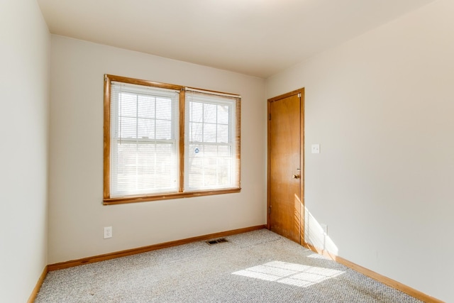 unfurnished room featuring light colored carpet