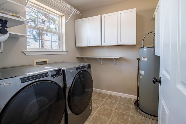 washroom with cabinets, gas water heater, light tile patterned flooring, and independent washer and dryer