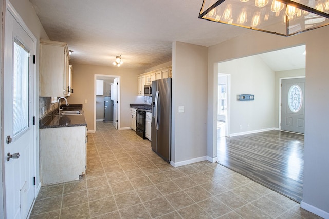 kitchen featuring stainless steel appliances, sink, and backsplash