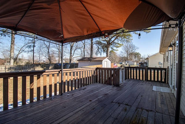 wooden terrace featuring a shed