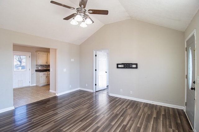 unfurnished living room with lofted ceiling, dark hardwood / wood-style floors, and ceiling fan