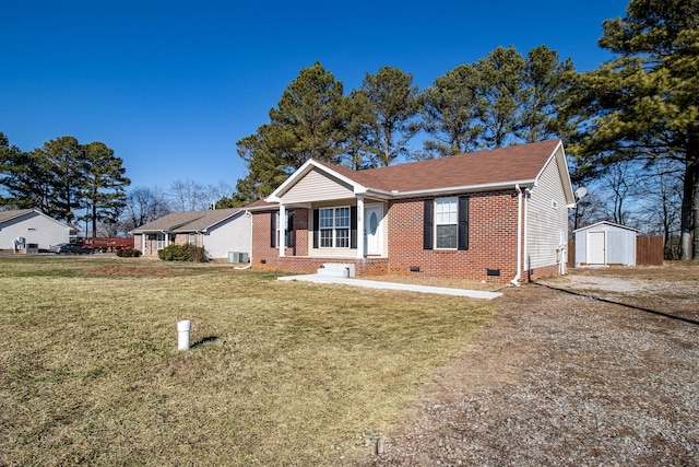 view of front of home featuring a front yard and a storage unit