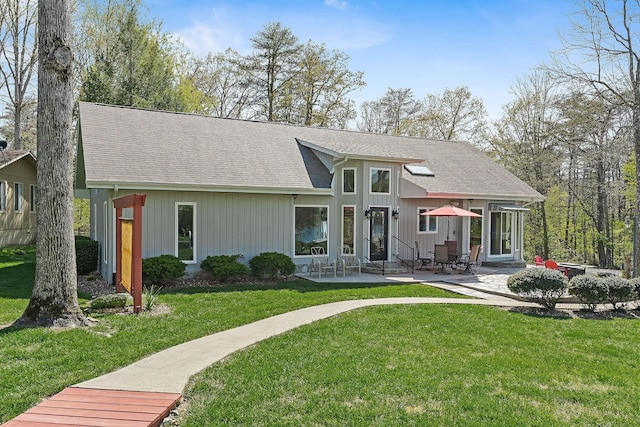 back of property featuring a patio area and a lawn