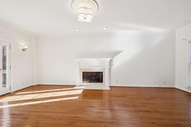 unfurnished living room featuring hardwood / wood-style floors and crown molding