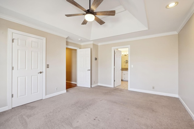 unfurnished bedroom with ceiling fan, connected bathroom, light carpet, and ornamental molding