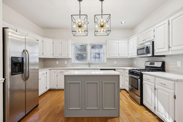 kitchen featuring white cabinetry, appliances with stainless steel finishes, and a kitchen island