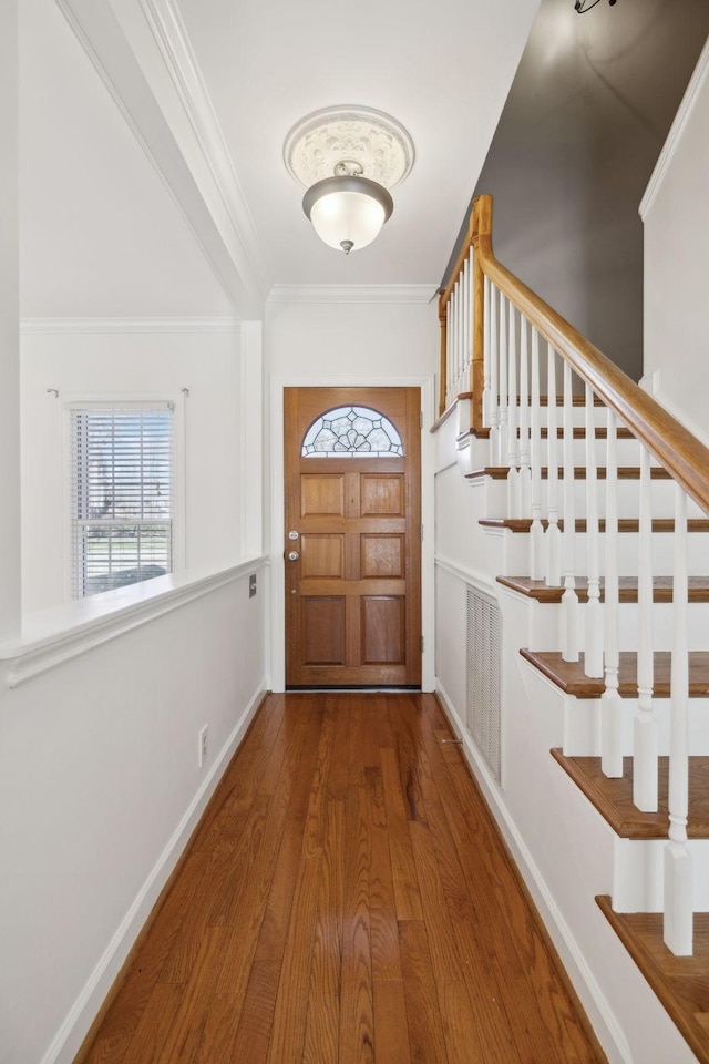 entryway featuring hardwood / wood-style flooring and crown molding