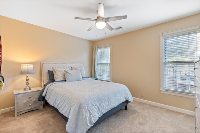 bedroom featuring ceiling fan and light colored carpet