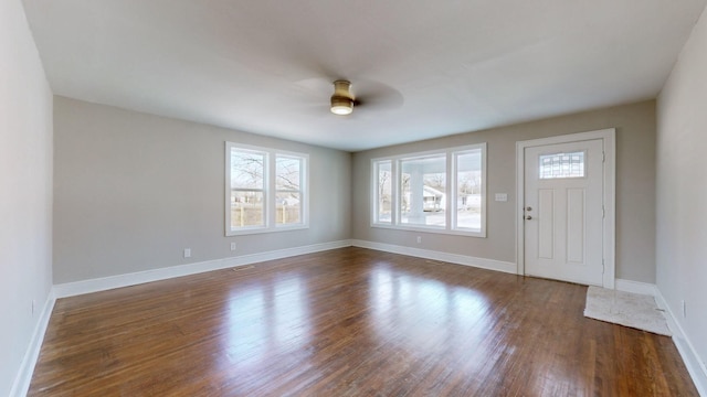 foyer entrance featuring ceiling fan, dark hardwood / wood-style floors, and a healthy amount of sunlight