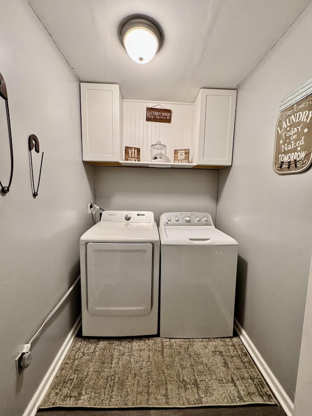 clothes washing area featuring cabinets and washing machine and dryer