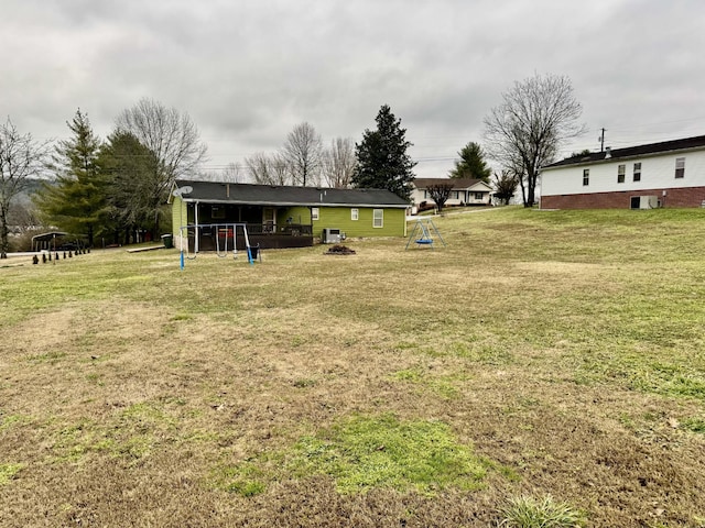 view of yard with an outdoor fire pit and a playground