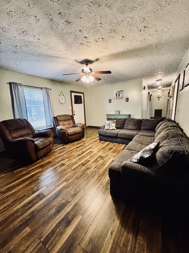 living room featuring a textured ceiling, ceiling fan, and wood-type flooring